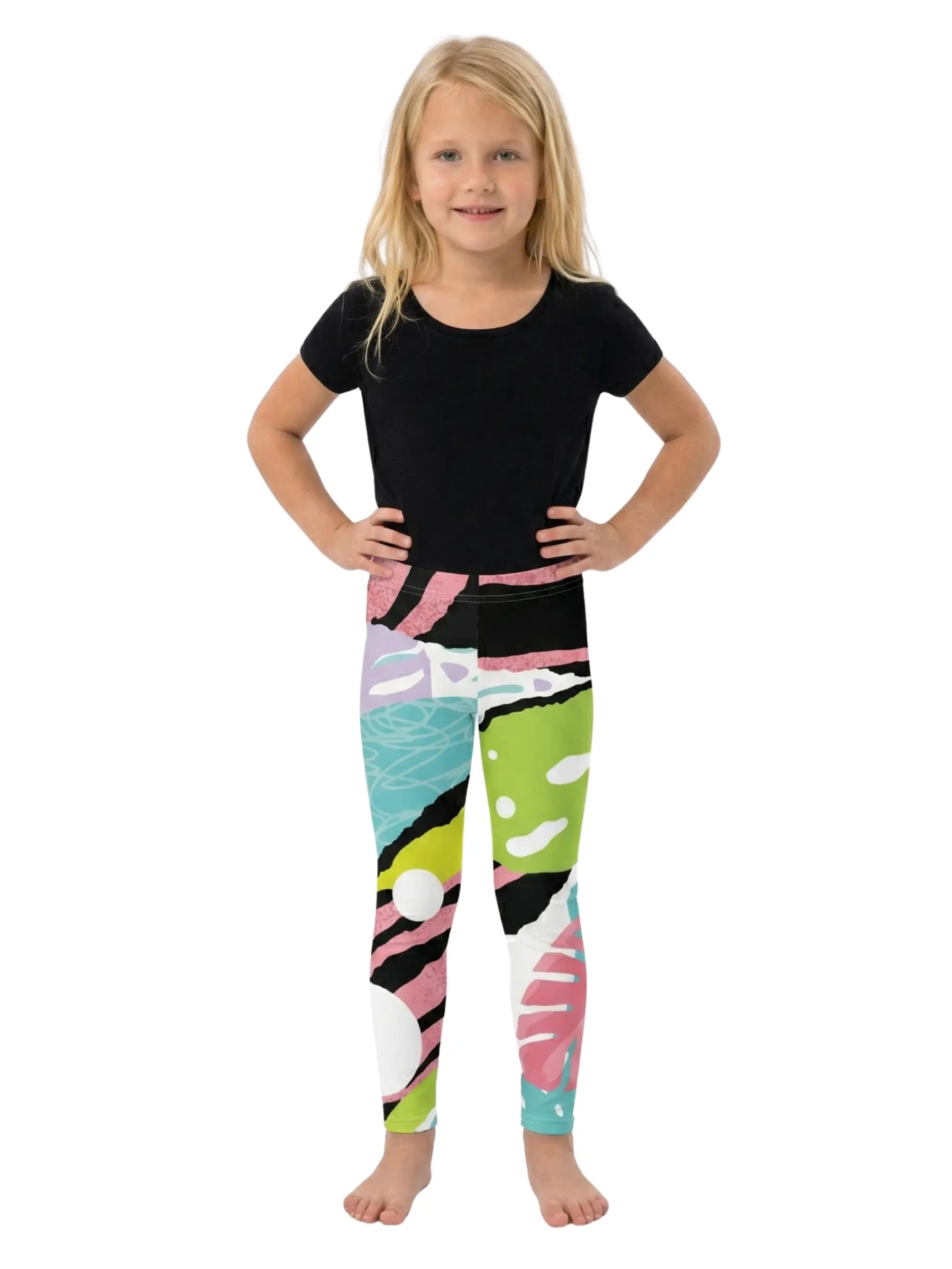 Young girl wearing a black top and colorful leggings on a white background
